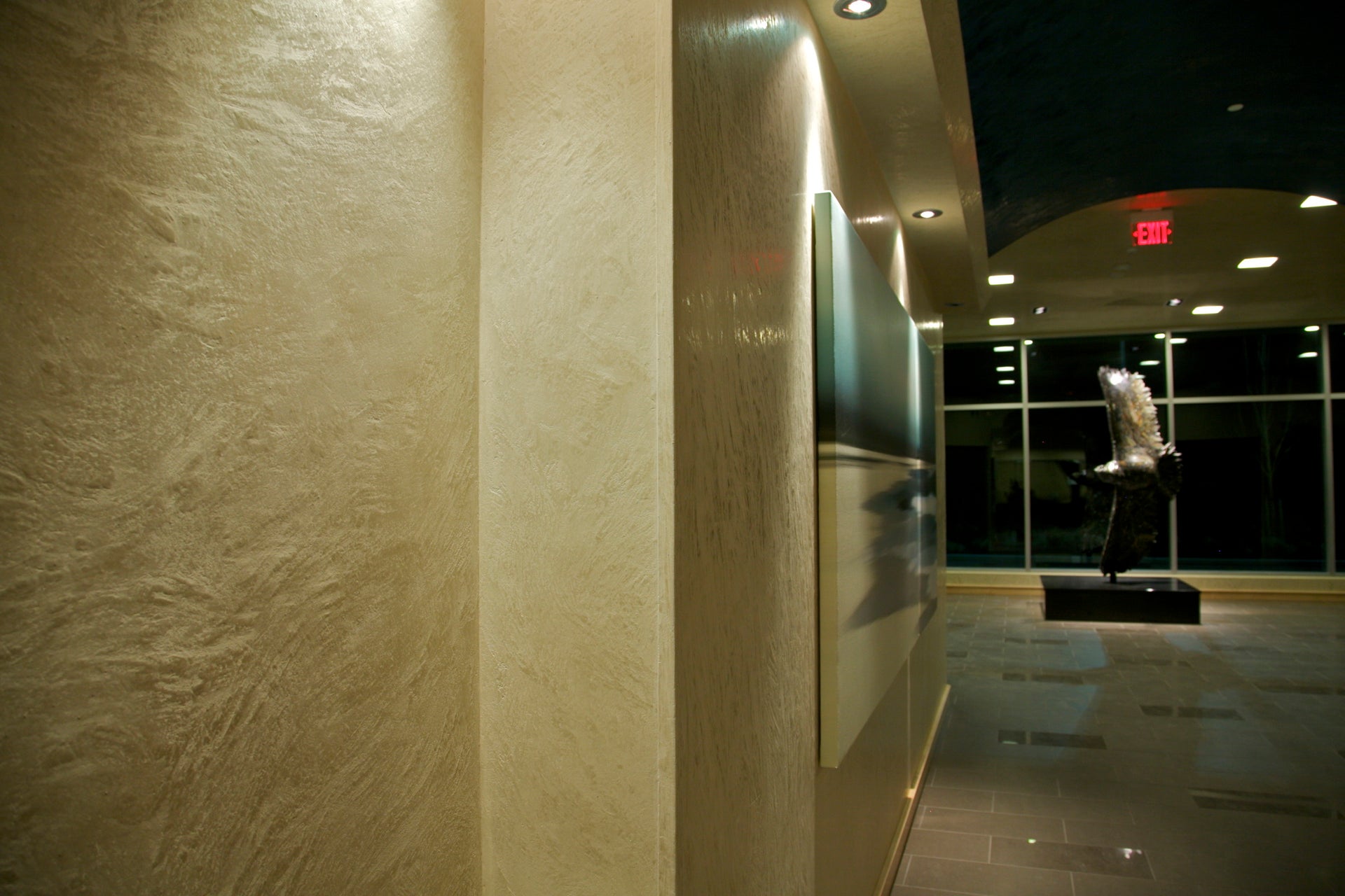 Carrara Marmorino plaster texture illuminated along an interior wall