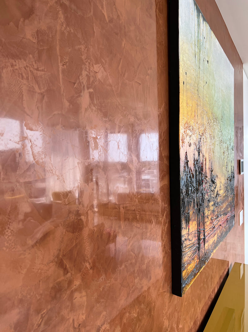 Polished terracotta Classic+ Venetian plaster wall beside framed artwork