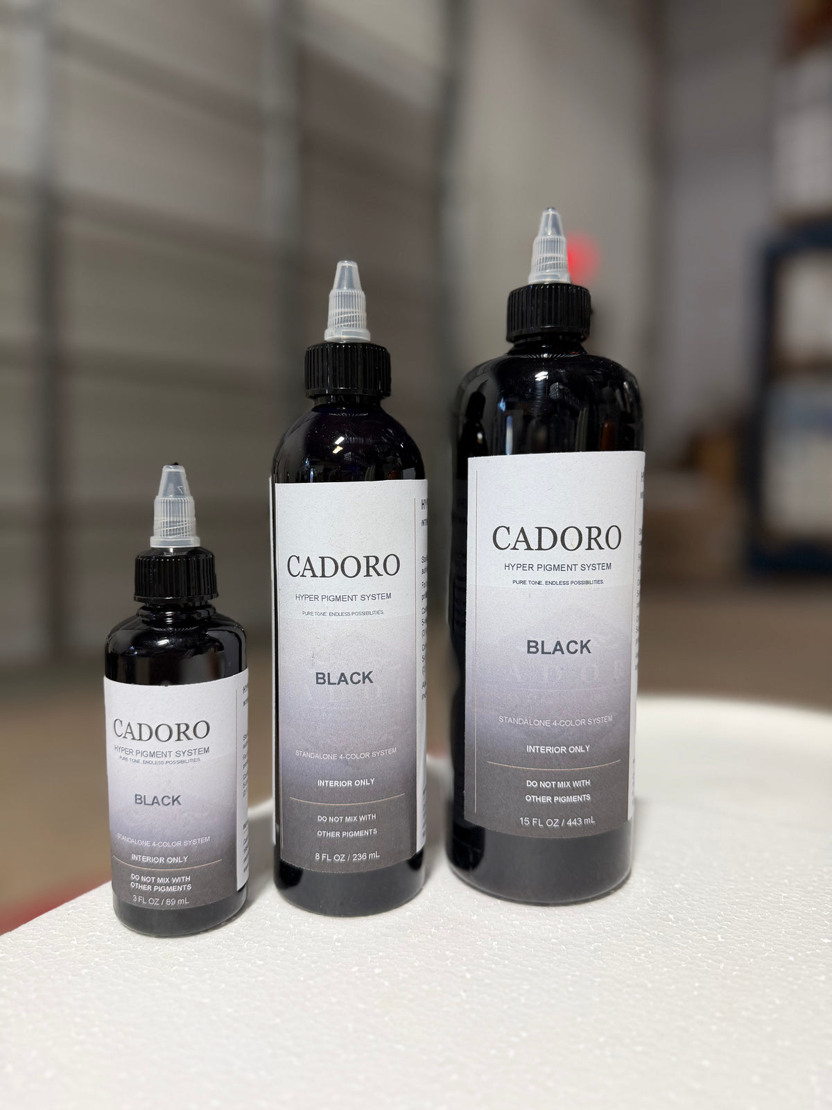 Cadoro Hyper black pigment bottles in 3 oz, 8 oz and 15 oz sizes