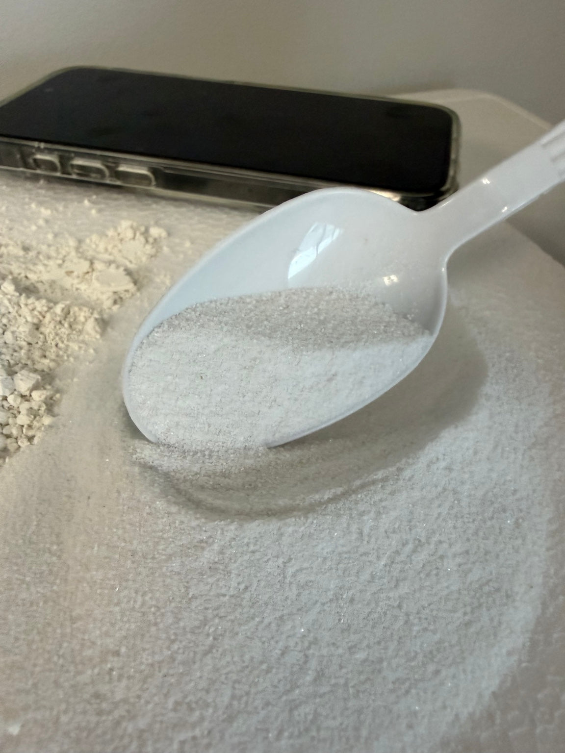 Cadoro Marble Powder Additive Extra Fine marble powder in spoon