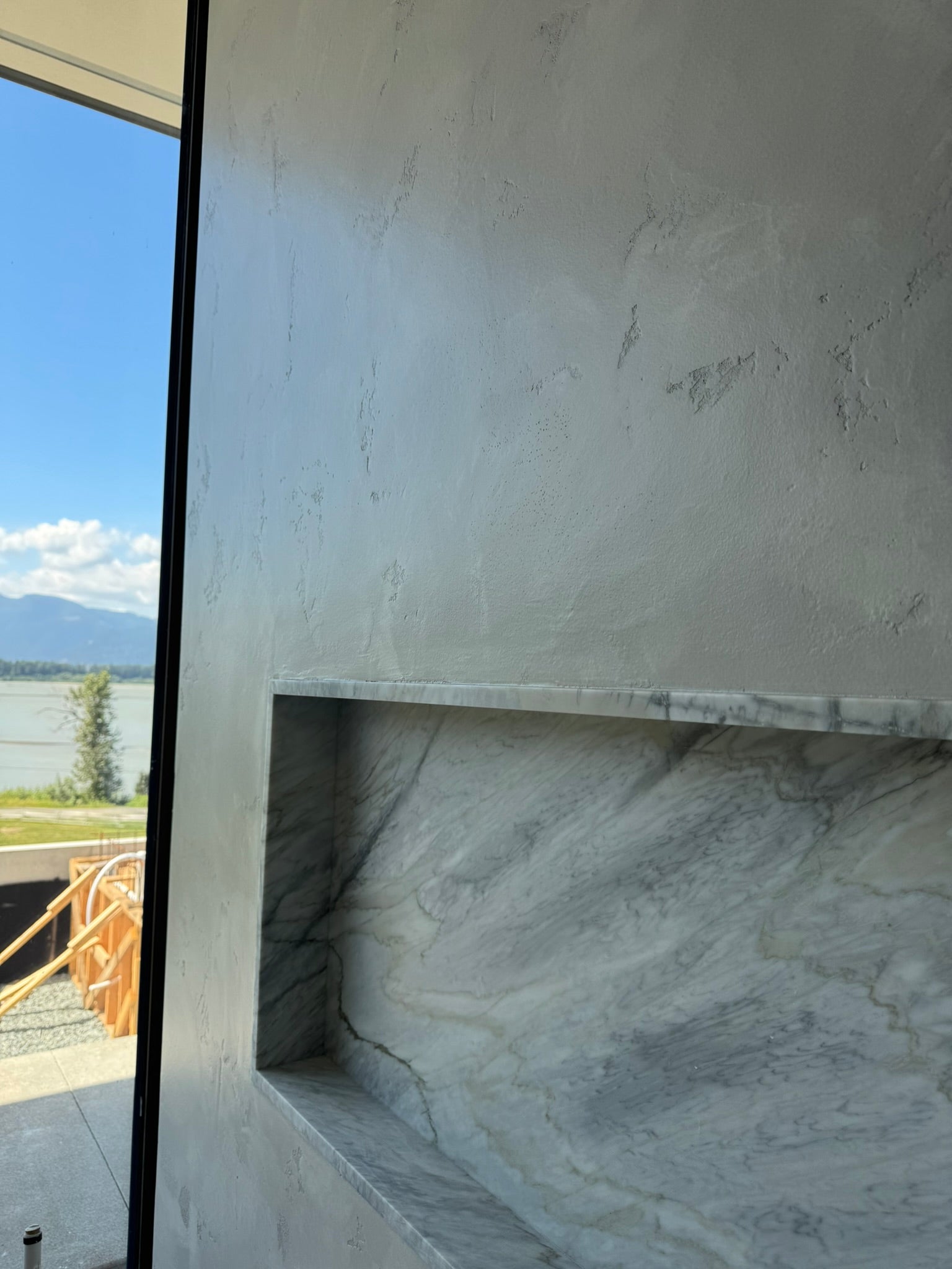 PoolCem textured wall beside a marble shower niche