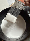 Cadoro Quartz Primer on a brush showing creamy quartz-filled consistency