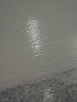 Close-up of freshly applied Cadoro Quartz Primer showing fine quartz texture